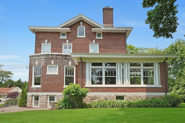 15 Calton Ln, New Rochelle, NY 10804 - back of house with a lawn, a chimney, and brick siding