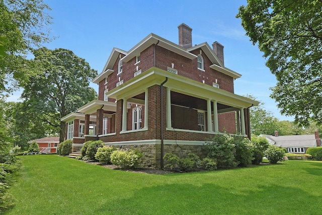15 Calton Ln, New Rochelle, NY 10804 - view of home's exterior featuring brick siding, a chimney, and a lawn