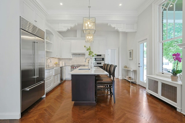 15 Calton Ln, New Rochelle, NY 10804 - kitchen with appliances with stainless steel finishes, open shelves, light countertops, ornamental molding, and white cabinets