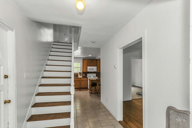 117 Glenwood Rd, Glenwood Landing, NY 11547 - staircase featuring a baseboard heating unit and tile patterned flooring