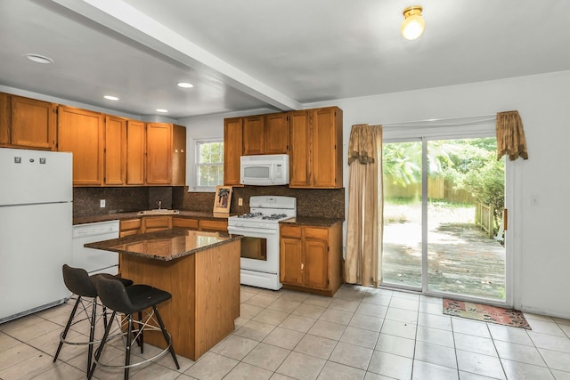 117 Glenwood Rd, Glenwood Landing, NY 11547 - kitchen featuring white appliances, healthy amount of natural light, backsplash, a center island, and recessed lighting