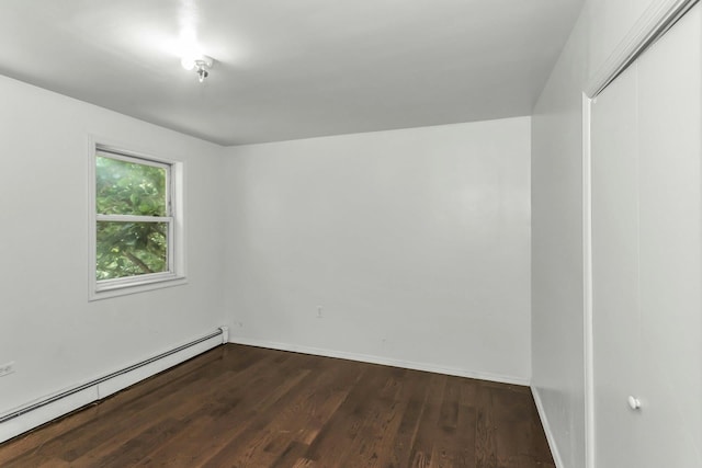 117 Glenwood Rd, Glenwood Landing, NY 11547 - empty room with a baseboard radiator and dark wood-style floors