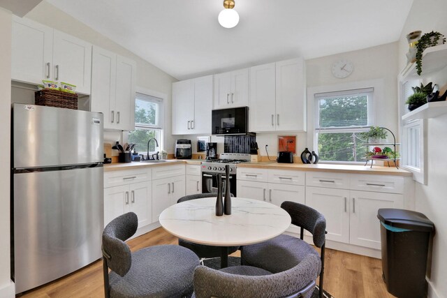 7 Brodie Rd # 17, Hopewell Junction, NY 12533 - kitchen featuring stainless steel appliances, white cabinetry, light countertops, and light wood-type flooring