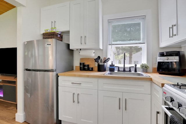 7 Brodie Rd # 17, Hopewell Junction, NY 12533 - kitchen with stainless steel appliances, white cabinetry, and wood counters