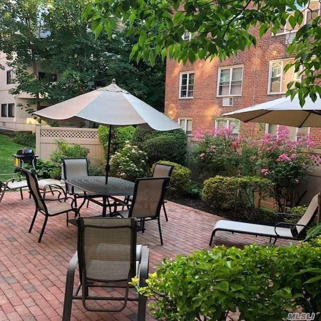 20 Chapel Pl Unit 1H, Great Neck, NY 11021 - view of patio / terrace with outdoor dining area and area for grilling