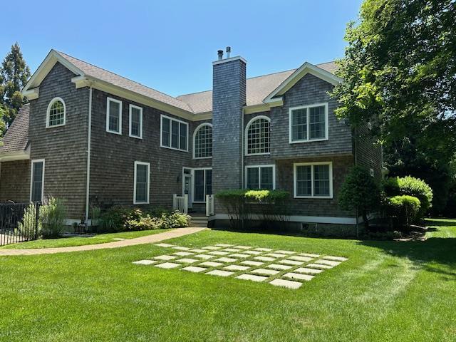 1 Sunset Ave, East Quogue, NY 11942 - back of property featuring a yard and a chimney