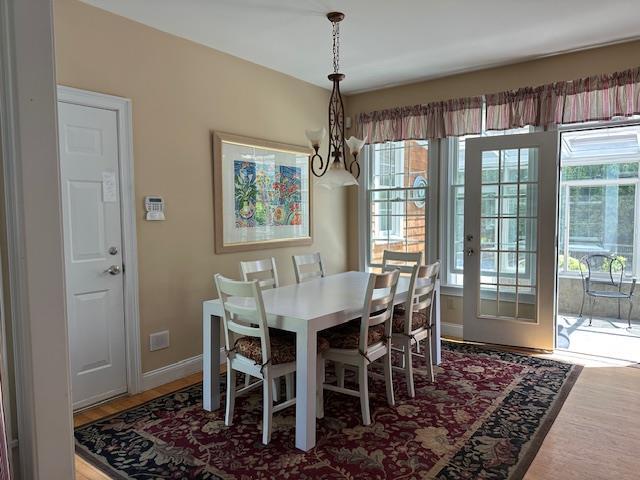 1 Sunset Ave, East Quogue, NY 11942 - dining area with plenty of natural light, a chandelier, and wood finished floors