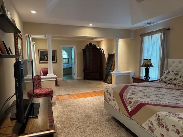 1 Sunset Ave, East Quogue, NY 11942 - bedroom with decorative columns, recessed lighting, ensuite bathroom, and light wood-type flooring