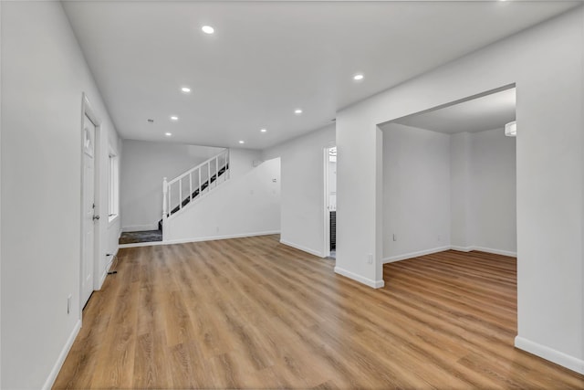 189 Jacob St, Elmont, NY 11003 - unfurnished living room with stairs, recessed lighting, and light wood-style floors