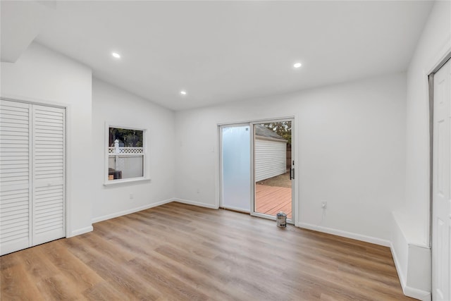 189 Jacob St, Elmont, NY 11003 - unfurnished bedroom with recessed lighting, light wood-style flooring, and vaulted ceiling