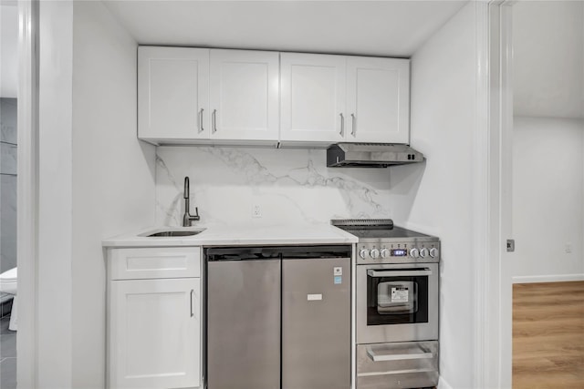 189 Jacob St, Elmont, NY 11003 - kitchen with stainless steel appliances, under cabinet range hood, white cabinets, and light countertops