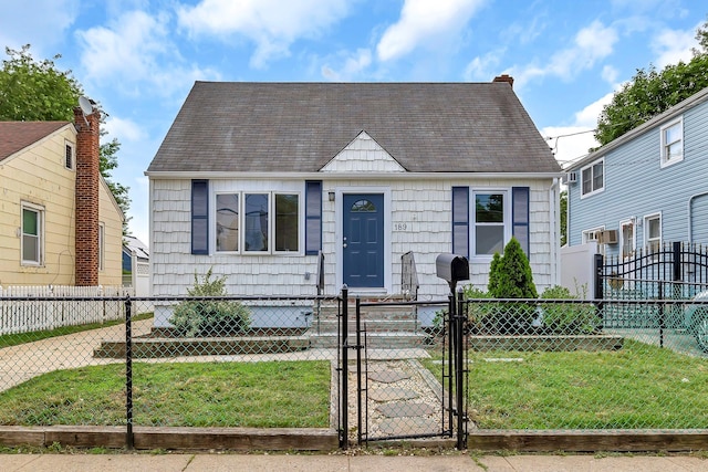 189 Jacob St, Elmont, NY 11003 - cape cod home featuring a gate, a fenced front yard, and roof with shingles