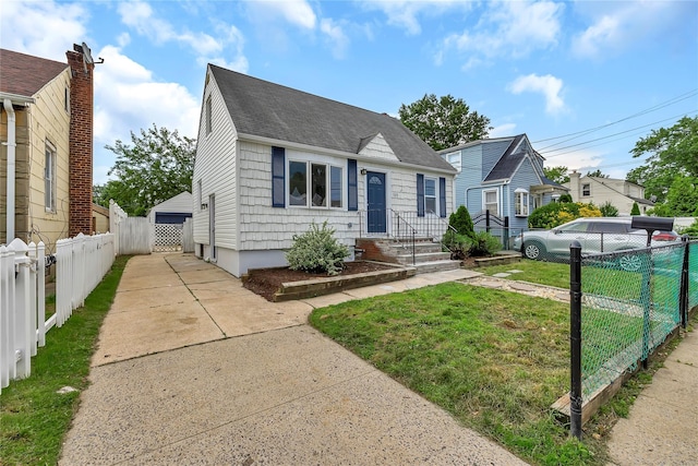 189 Jacob St, Elmont, NY 11003 - view of front of property featuring a shingled roof and a detached garage