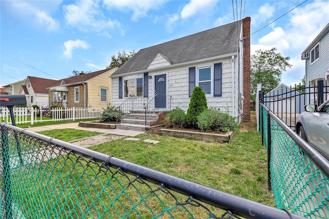 189 Jacob St, Elmont, NY 11003 - view of front of house featuring roof with shingles, a chimney, and a residential view