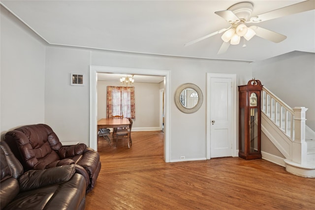 35 Juniper Ave, Mineola, NY 11501 - living area with wood finished floors, stairs, a chandelier, and ceiling fan