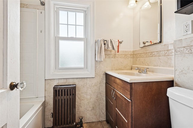 35 Juniper Ave, Mineola, NY 11501 - full bath featuring radiator heating unit, vanity, plenty of natural light, tile walls, and wainscoting