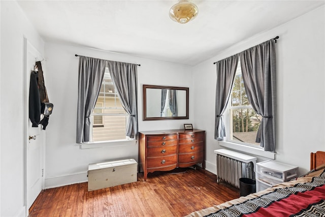 35 Juniper Ave, Mineola, NY 11501 - bedroom with radiator, hardwood / wood-style flooring, and multiple windows