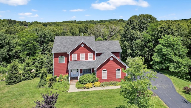 2 Primrose Ln, Chester, NY 10918 - view of front of house with a forest view, a front lawn, a shingled roof, and driveway
