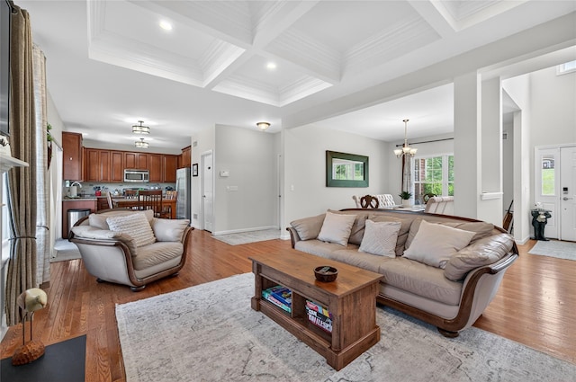 2 Primrose Ln, Chester, NY 10918 - living area with coffered ceiling, light wood-type flooring, a chandelier, beamed ceiling, and crown molding