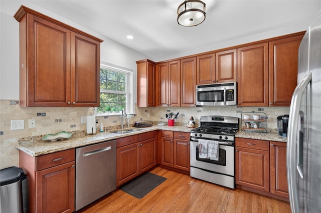 2 Primrose Ln, Chester, NY 10918 - kitchen featuring appliances with stainless steel finishes, light wood-style floors, backsplash, light stone counters, and recessed lighting