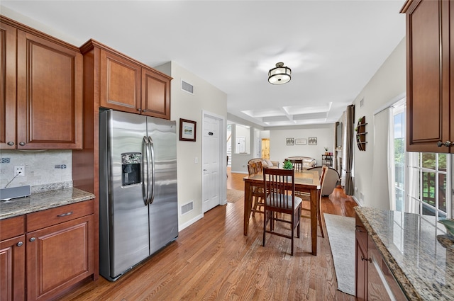 2 Primrose Ln, Chester, NY 10918 - kitchen with stainless steel fridge with ice dispenser, light wood finished floors, backsplash, brown cabinets, and dark stone countertops