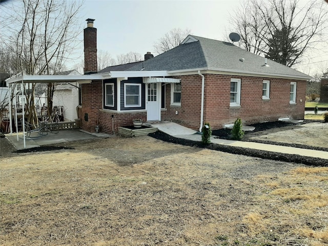 8 Poplar St, Poughkeepsie, NY 12601 - rear view of property with brick siding, a chimney, a shingled roof, and a patio