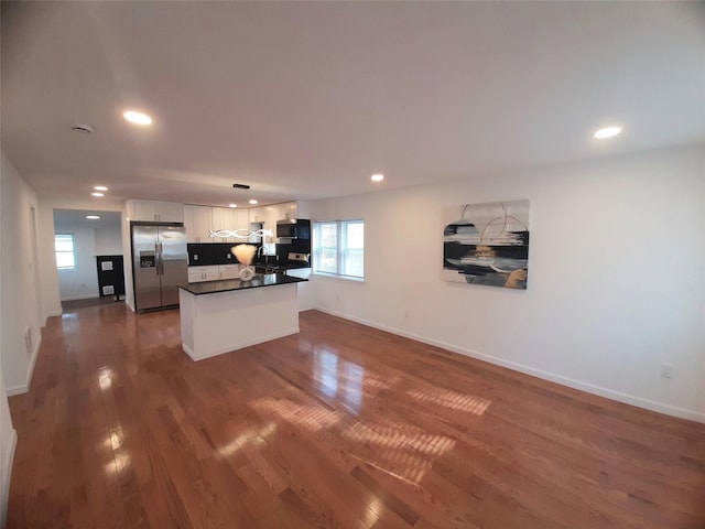 8 Poplar St, Poughkeepsie, NY 12601 - kitchen featuring stainless steel refrigerator with ice dispenser, white cabinets, dark countertops, recessed lighting, and dark wood-style floors