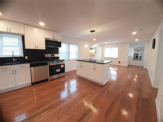 8 Poplar St, Poughkeepsie, NY 12601 - kitchen featuring appliances with stainless steel finishes, dark countertops, recessed lighting, and light wood-type flooring