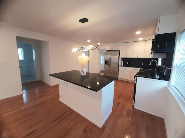 8 Poplar St, Poughkeepsie, NY 12601 - kitchen featuring stainless steel fridge, dark countertops, white cabinets, dark wood-type flooring, and recessed lighting