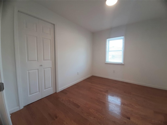 8 Poplar St, Poughkeepsie, NY 12601 - unfurnished bedroom with wood finished floors and baseboards