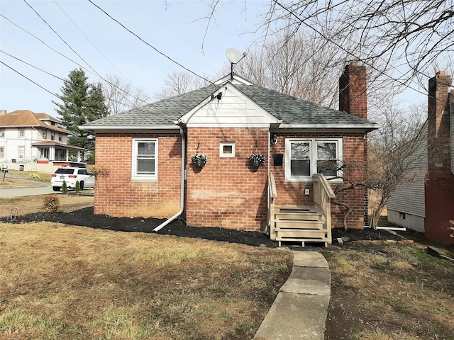 8 Poplar St, Poughkeepsie, NY 12601 - bungalow-style home with roof with shingles, a chimney, and brick siding