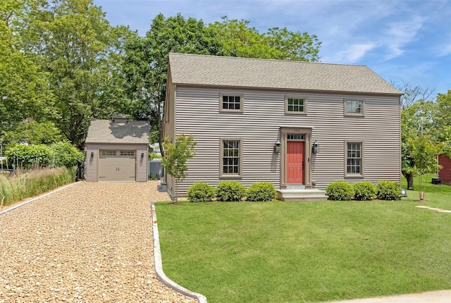 130 Sunset Ln, Greenport, NY 11944 - colonial house featuring gravel driveway, an outdoor structure, a front yard, and a shingled roof