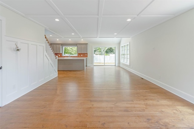 130 Sunset Ln, Greenport, NY 11944 - unfurnished living room featuring recessed lighting, stairs, light wood-style floors, and coffered ceiling