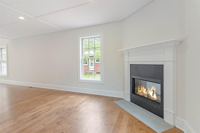 130 Sunset Ln, Greenport, NY 11944 - unfurnished living room with a fireplace with flush hearth, wood finished floors, and recessed lighting