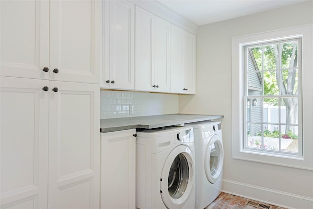 130 Sunset Ln, Greenport, NY 11944 - laundry area featuring cabinet space and separate washer and dryer