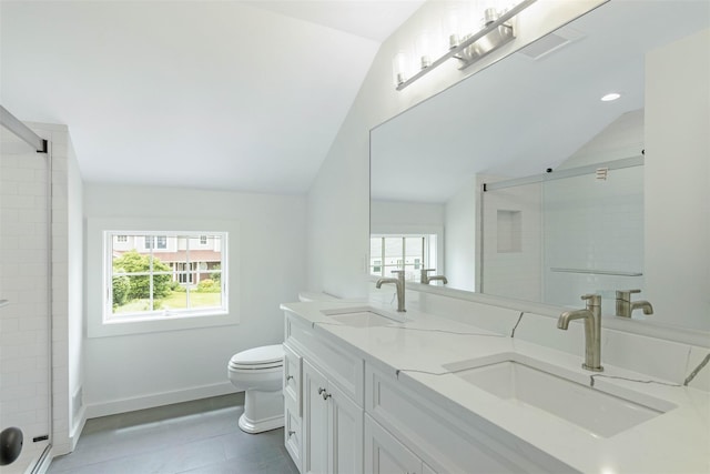 130 Sunset Ln, Greenport, NY 11944 - full bath with vaulted ceiling, plenty of natural light, double vanity, and a stall shower