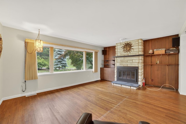 25 Tappan Ter, Briarcliff Manor, NY 10510 - unfurnished living room with wood finished floors and a stone fireplace