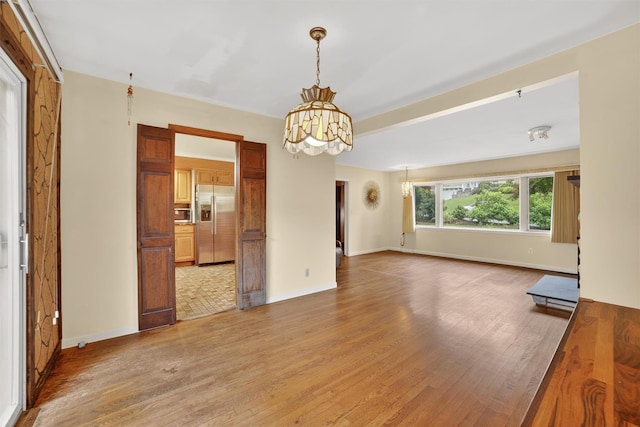 25 Tappan Ter, Briarcliff Manor, NY 10510 - unfurnished living room with a chandelier and light wood-type flooring