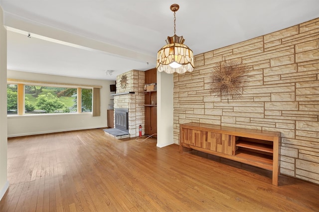 25 Tappan Ter, Briarcliff Manor, NY 10510 - unfurnished living room with a stone fireplace, wood finished floors, and a chandelier