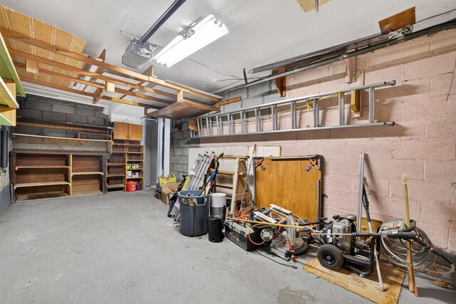 25 Tappan Ter, Briarcliff Manor, NY 10510 - garage featuring concrete block wall and a garage door opener
