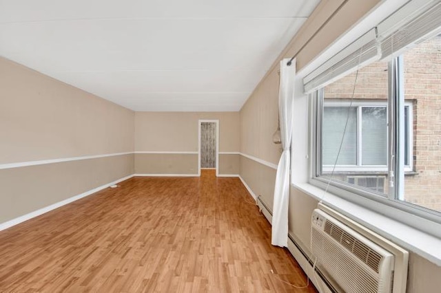 2035 Central Park Ave Unit 3M, Yonkers, NY 10710 - empty room featuring light wood-style flooring, a wall unit AC, and a baseboard heating unit