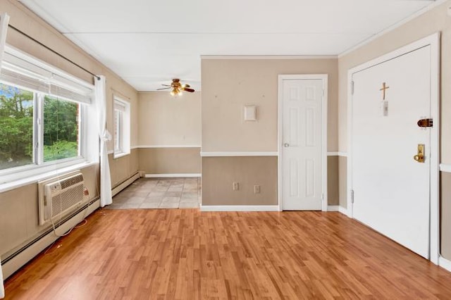 2035 Central Park Ave Unit 3M, Yonkers, NY 10710 - empty room with a ceiling fan, light wood-style flooring, a baseboard heating unit, a wall mounted AC, and crown molding
