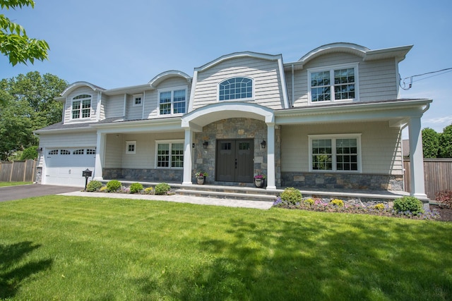 53 Calvin Ave, Syosset, NY 11791 - view of front of home featuring stone siding, a porch, asphalt driveway, and an attached garage