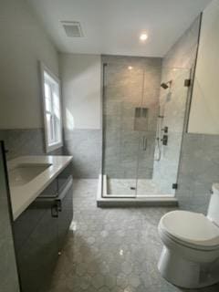 53 Calvin Ave, Syosset, NY 11791 - bathroom with tile walls, vanity, and a shower stall