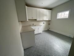 53 Calvin Ave, Syosset, NY 11791 - laundry area featuring cabinet space and baseboards