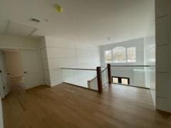 53 Calvin Ave, Syosset, NY 11791 - hallway featuring wood finished floors and an upstairs landing