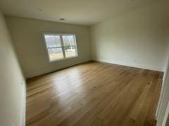 53 Calvin Ave, Syosset, NY 11791 - spare room featuring wood finished floors