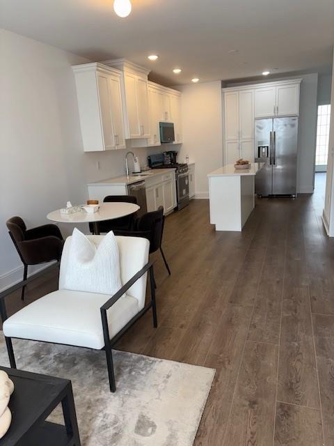 506 Emanuel Way Unit 73, East Meadow, NY 11554 - kitchen with appliances with stainless steel finishes, light countertops, dark wood-type flooring, white cabinetry, and recessed lighting