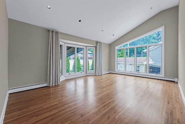 709 Demott Ct, Westbury, NY 11590 - unfurnished room featuring baseboard heating, vaulted ceiling, wood finished floors, and recessed lighting