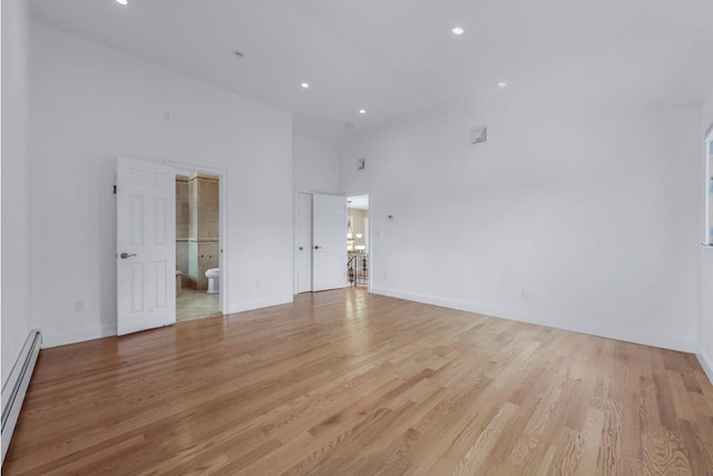 709 Demott Ct, Westbury, NY 11590 - unfurnished room with baseboard heating, light wood-type flooring, recessed lighting, and high vaulted ceiling